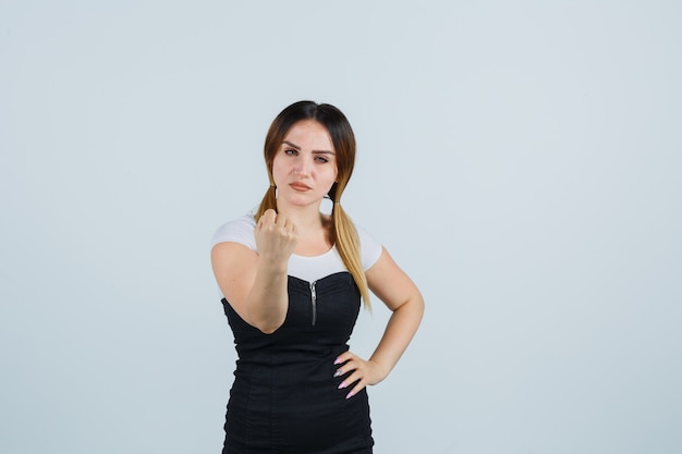 Blonde junge Dame im Kleid gestikuliert isoliert