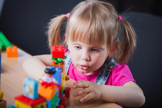 Blonde Mädchen spielen mit Spielzeug Zug