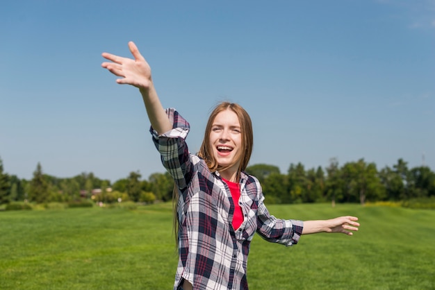 Blondes Mädchen, das einen Frisbee wirft