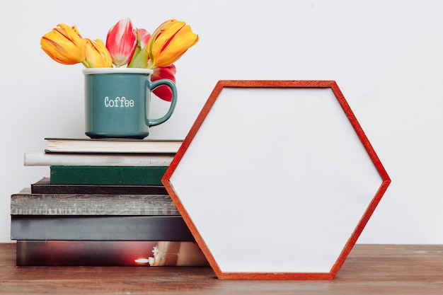 Blumen auf Büchern nähern sich Hexagonrahmen