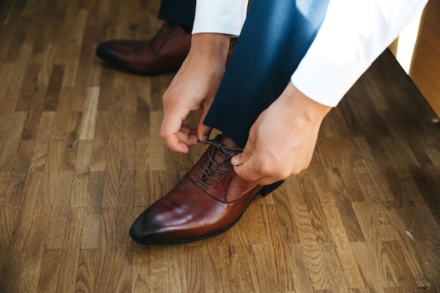 Bräutigam bindet Schnürsenkel an seinen Schuhen