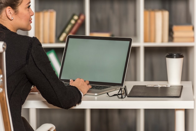 Brunettegeschäftsfrau, die in ihrem Büro arbeitet