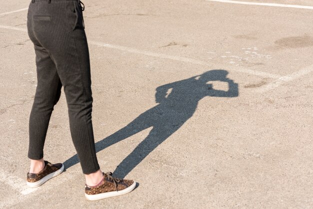 Brunettegeschäftsfrauschatten draußen