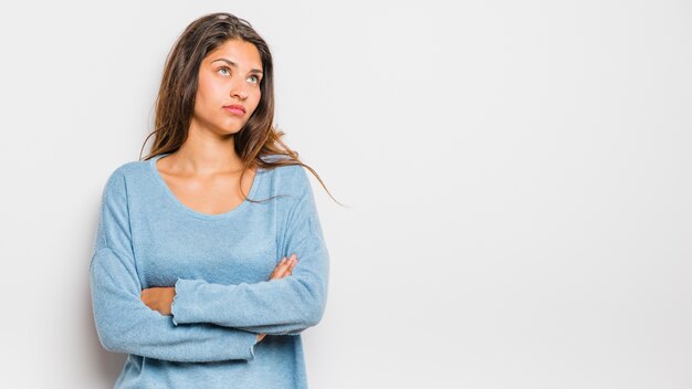 Brunettemädchen, das mit blauer Strickjacke aufwirft