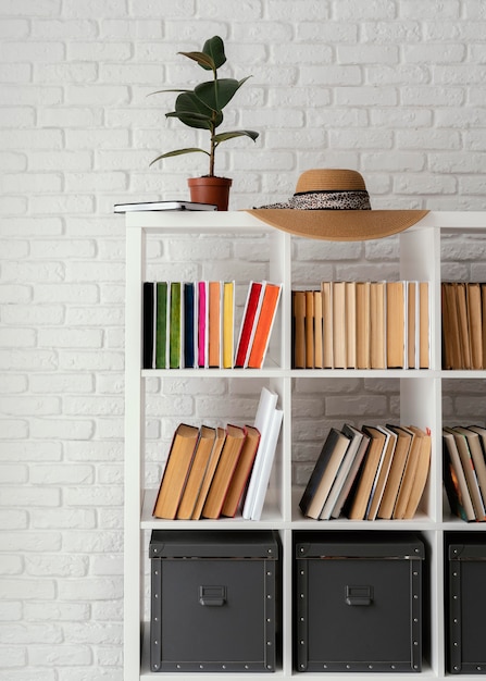 Bücherregal mit Pflanze und Hut