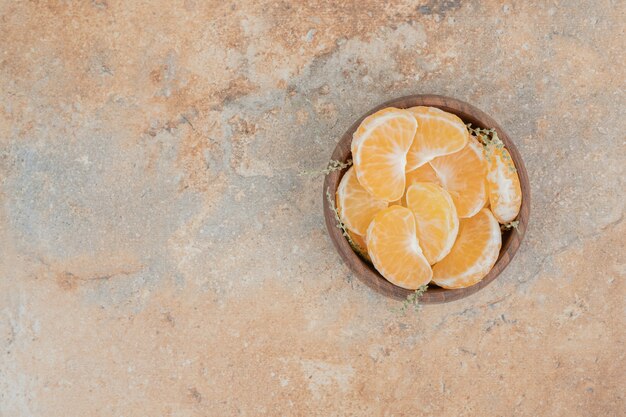 Bündel mandarinenscheiben auf holzschale.