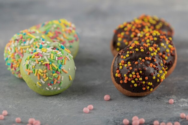 Kostenloses Foto bunte kleine donuts der süßen schokolade mit streuseln.