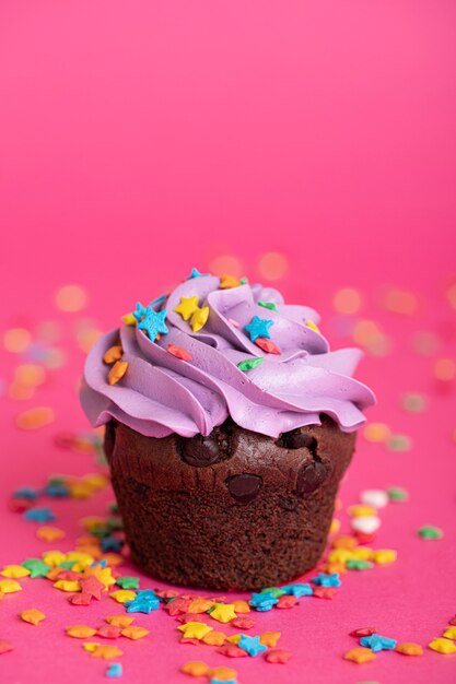 Bunter köstlicher Cupcake mit Zuckerguss an der Spitze