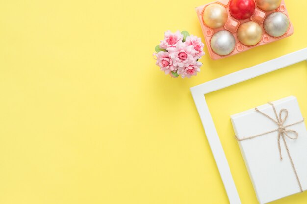 Buntes Osterei der Draufsicht der Draufsicht legen gemalt in der Pastellfarbzusammensetzung und in den Frühlingsblumen