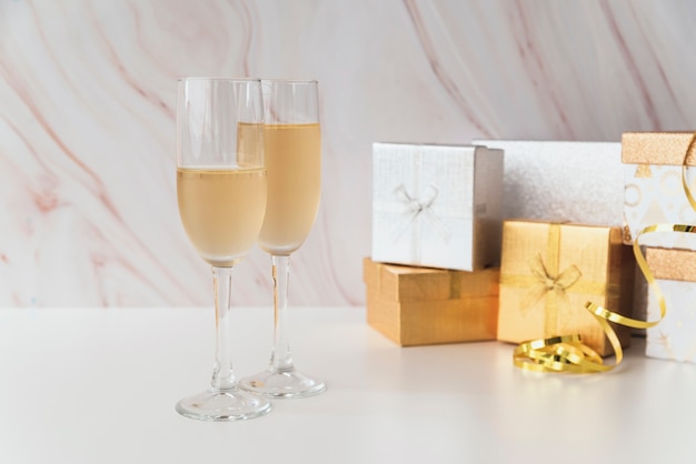 Champagne-Gläser mit Geschenken auf der Tabelle