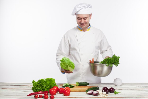 Chef, der Frischgemüsesalat in seiner Küche kocht