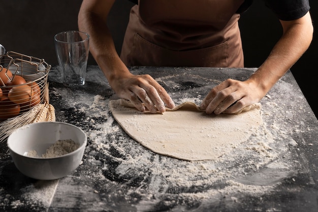 Chef rollt Teig, um Gebäck zu machen