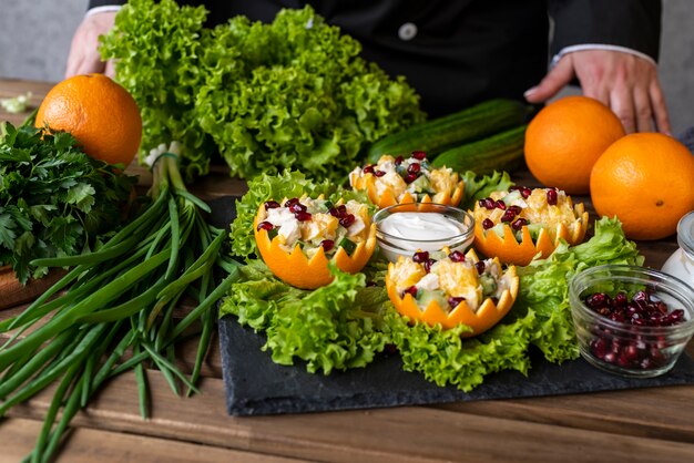 Chefkoch, der Gericht mit Salat präsentiert