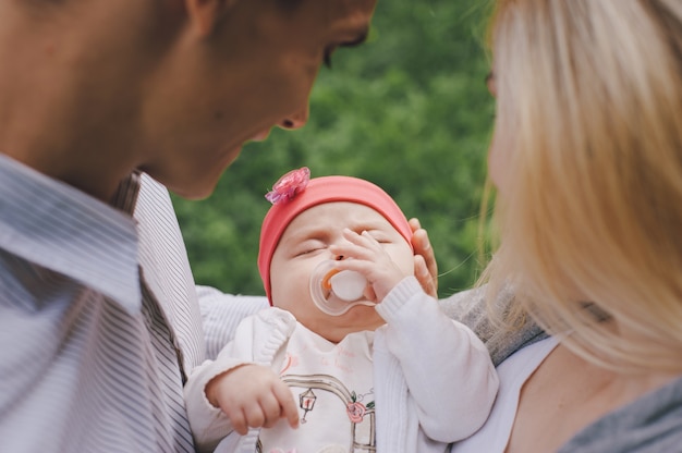 Close-up der jungen Eltern ihr Baby halten