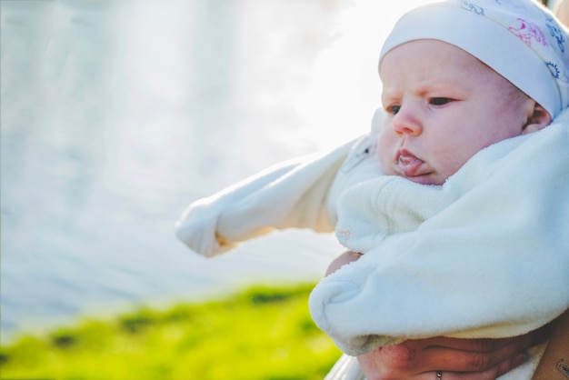 Kostenloses Foto close-up von baby mit see hintergrund