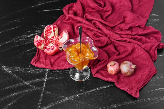 Confiture auf rotem Handtuch mit Granatapfel