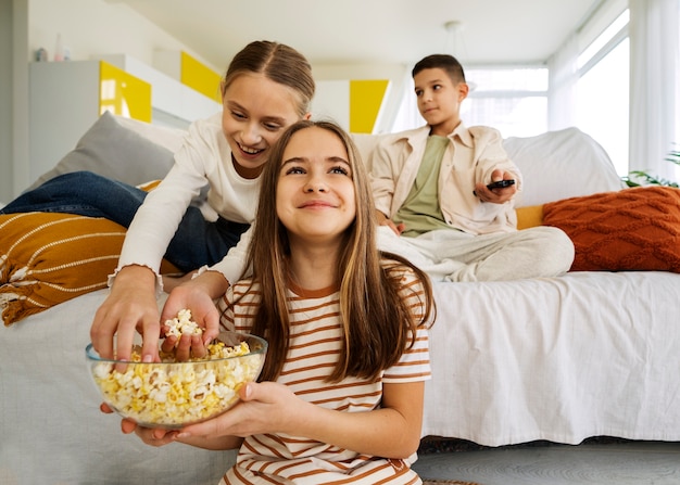 Kostenloses Foto cousins verbringen zeit zusammen zu hause und schauen fern