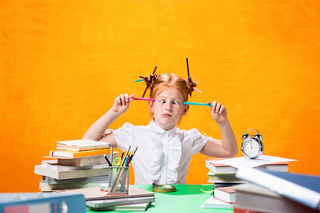 Das jugendlich Mädchen der Rothaarigen mit vielen Büchern zu Hause.