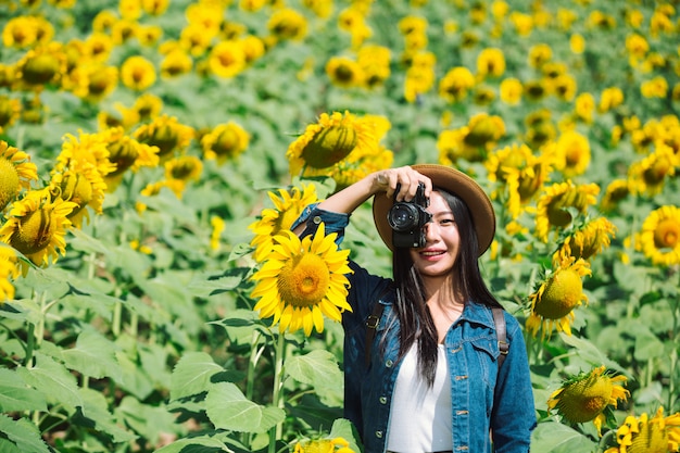 Das Mädchen fotografiert gerne im Sonnenblumenfeld.