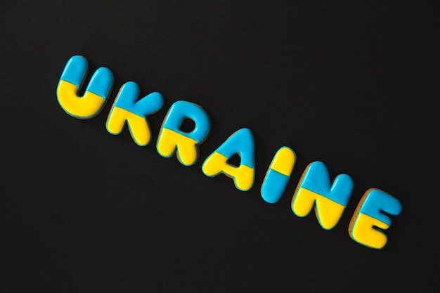 Kostenloses Foto das wort ukraine auf schwarzem hintergrund mit handgemachtem lebkuchen