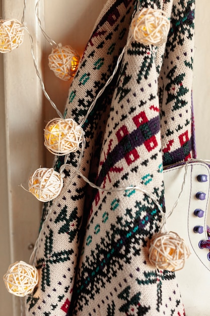 Kostenloses Foto dekoration mit pullover und schlittschuhen auf kleiderbügel