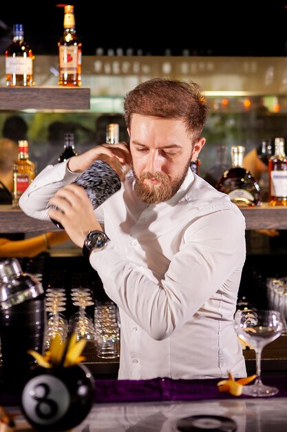 Der Barkeeper bereitet in der Lounge einen Cocktail zu