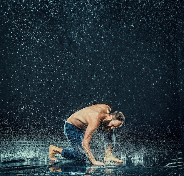 Der männliche Breakdancer im Wasser.