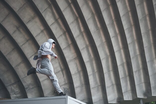 Der Mann im Freien übt Parkour, extreme Akrobatik.