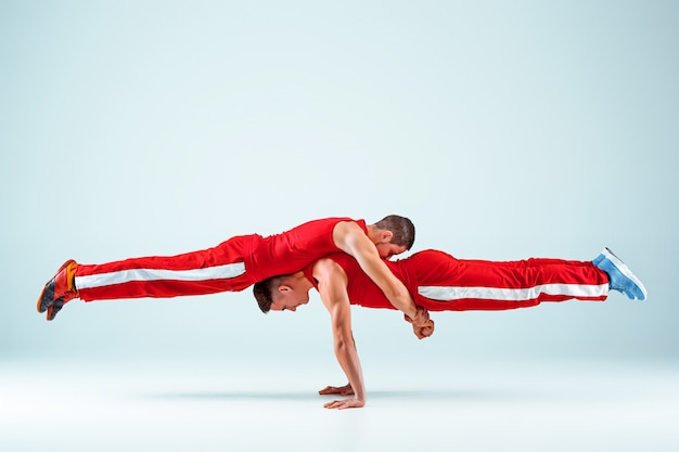 Die beiden akrobatischen Männer posieren im Gleichgewicht