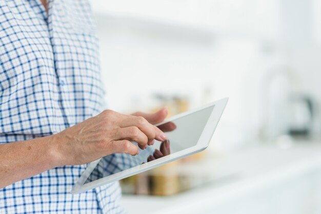 Die Hand der Frau, die digitalen Tablettenschirm berührt