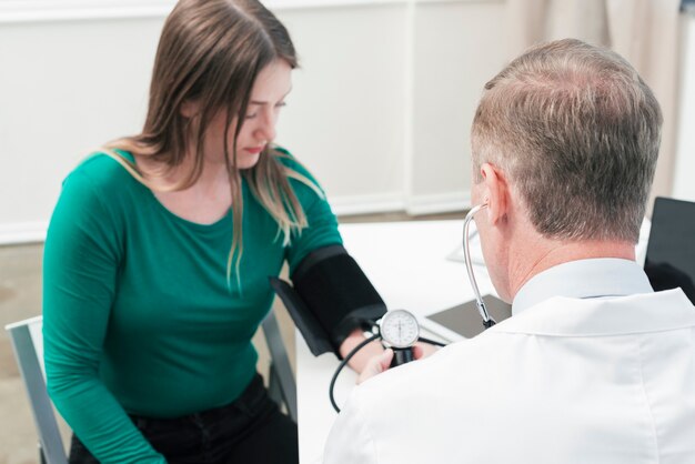 Doktor, der zu einem Patienten neigt