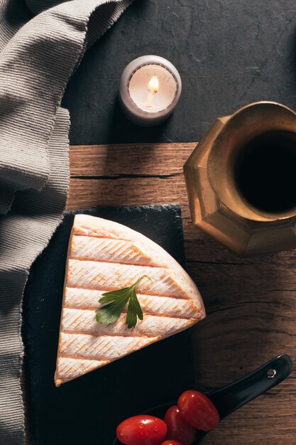 Draufsicht auf den köstlichen französischen Brie-Käse mit roten Tomaten