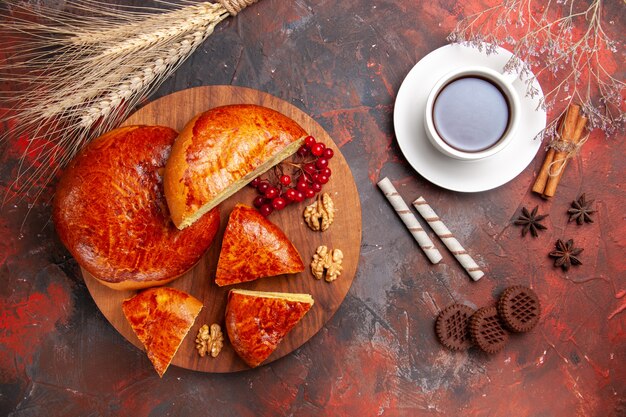 Draufsicht auf leckere Kuchen, die mit roten Beeren geschnitten werden