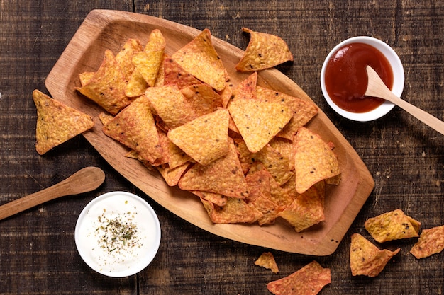 Kostenloses Foto draufsicht auf nacho-chips mit soße und ketchup