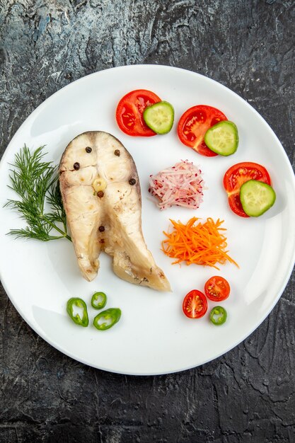 Draufsicht auf rohe Fische und frische Paprika-Lebensmittel auf weißem Teller auf Eisfläche mit freiem Platz