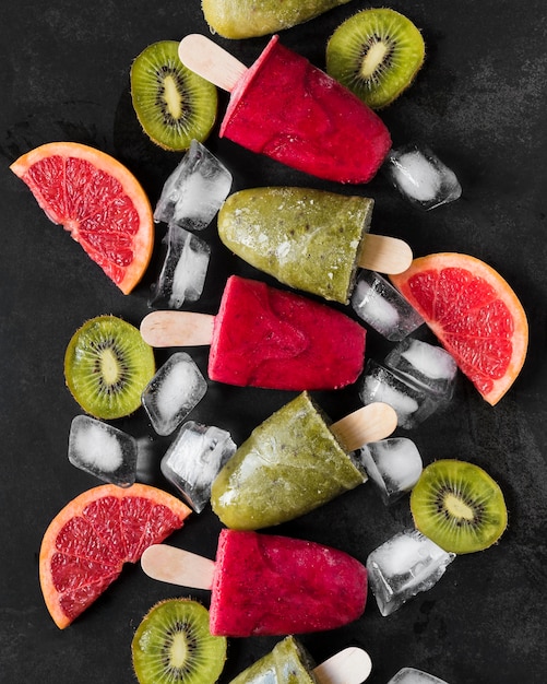 Draufsicht auf rote Grapefruit- und Kiwi-Eis am Stiel