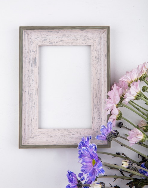 Draufsicht der schönen blassrosa und violetten Gänseblümchenblumen auf einem weißen Hintergrund mit Kopienraum