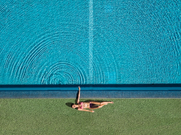 Draufsicht des mädchens entspannend nahe bei pool