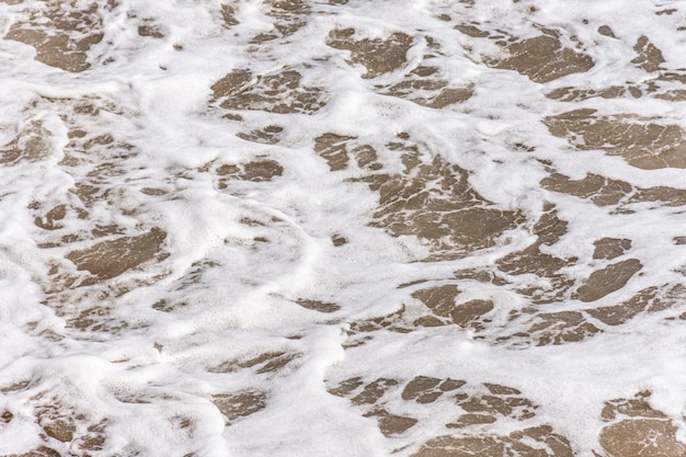 Draufsicht des Strandes mit Wasser und Schaum