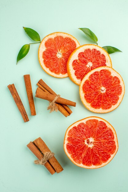 Draufsicht frische leckere Grapefruits mit Zimt auf hellblauem Hintergrund