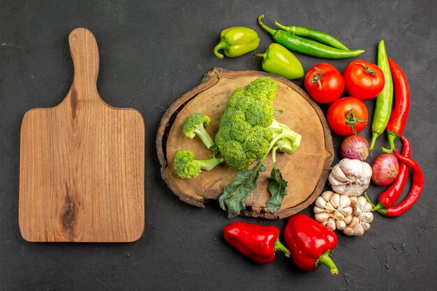 Draufsicht frischer grüner Brokkoli mit frischem Gemüse auf dem dunklen Tischsalat reife Gesundheit