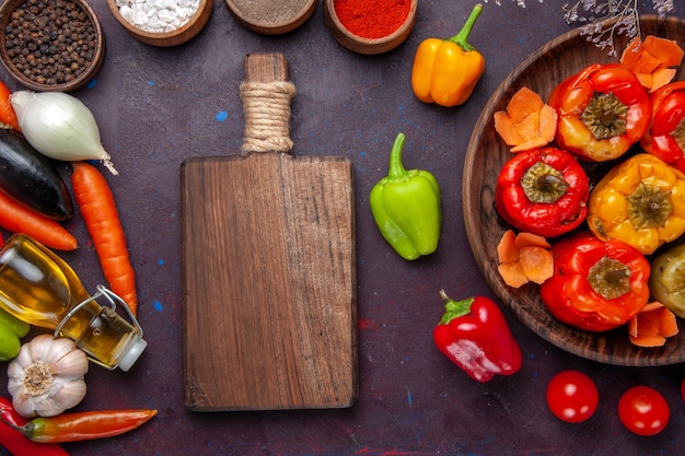 Draufsicht gekochte Paprika mit frischem Gemüse und Gewürzen auf grauem Oberflächenmehl Dolma-Gemüse-Rindfleisch