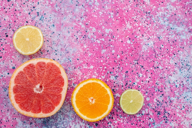 Draufsicht Grapefruitring mit geschnittener Orange und Zitrone auf der farbigen Hintergrundfrucht Zitrus exotische Farbe