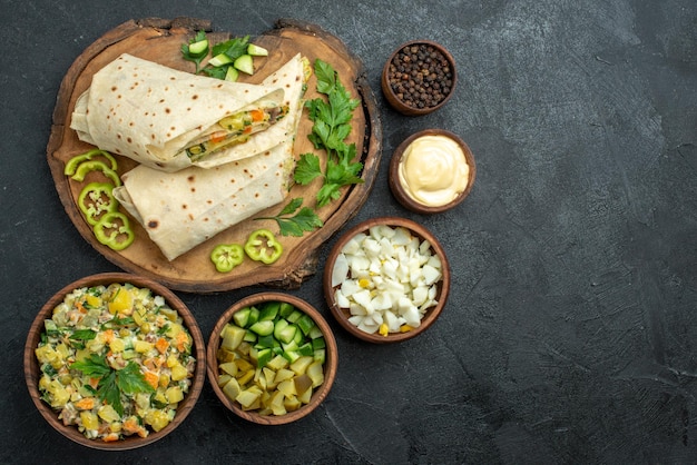 Draufsicht in Scheiben geschnitten leckeres Shaurma-Salat-Sandwich mit Gemüse auf grauer Oberfläche Pita-Mahlzeit-Salat-Sandwich-Burger