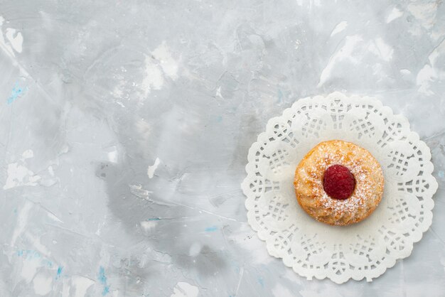 Draufsicht kleiner Sahnekuchen mit Himbeere auf der hellen Oberfläche Frucht süß