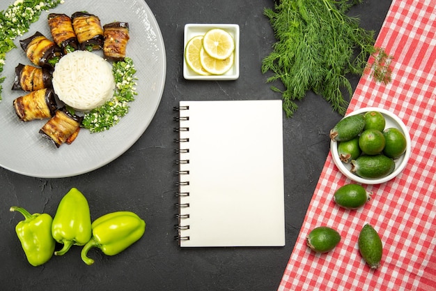 Kostenloses Foto draufsicht köstliche gekochte auberginen mit reis feijoa und zitronenscheiben auf dunkler oberfläche abendessen essen kochen reismehl