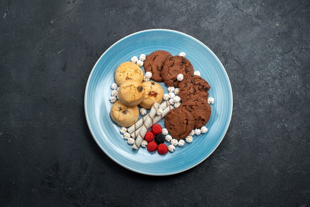 Draufsicht köstliche Kekse Schokolade und einfache mit Süßigkeiten auf dunkelgrauem Oberflächenzuckerkekskuchen süßer Keks