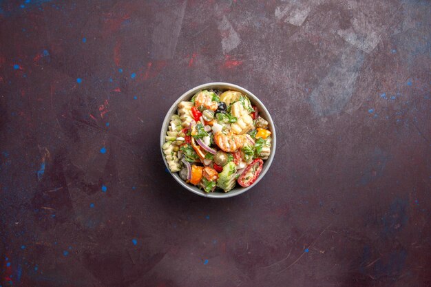 Draufsicht köstlicher Gemüsesalat besteht aus Tomaten, Oliven und Paprika auf dunklem Hintergrund