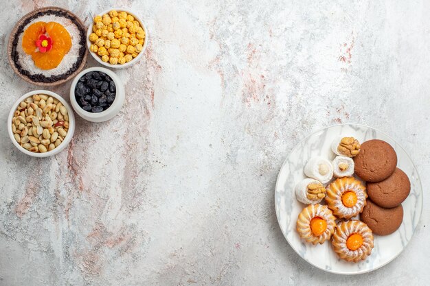 Draufsicht köstliches Schokoladendessert mit Nüssen und Rosinen auf weißem Hintergrund Nusssnack Dessertkuchen