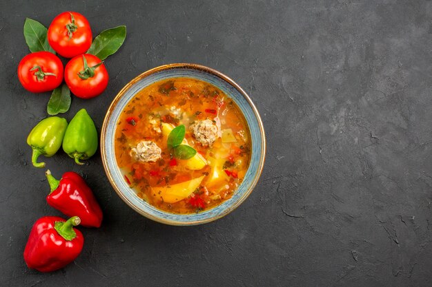 Draufsicht leckere Fleischbällchensuppe mit Gemüse auf den dunklen Tischsaucenschalenfarben